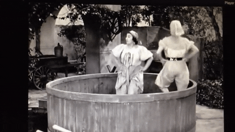 GIF from I Love Lucy of Lucy dancing around in a vat of grapes