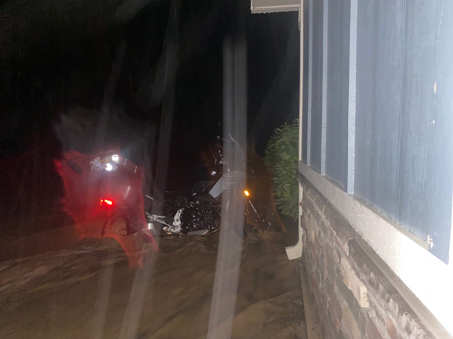 Motorcycle in floodwaters with reflectors responding to phone flash
