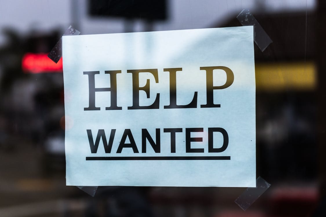 Free Help Wanted Sign on Glass Stock Photo