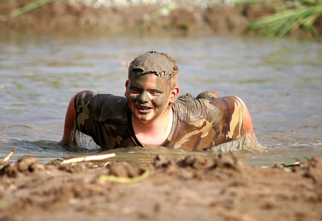 What could be better for a young country boy than a mud pit made specifically for the purpose of doing belly flops? Not much, according to Jackson Lukens of Knightstown, shown here emerging from the chocolate pudding-like depths of a mud pit.