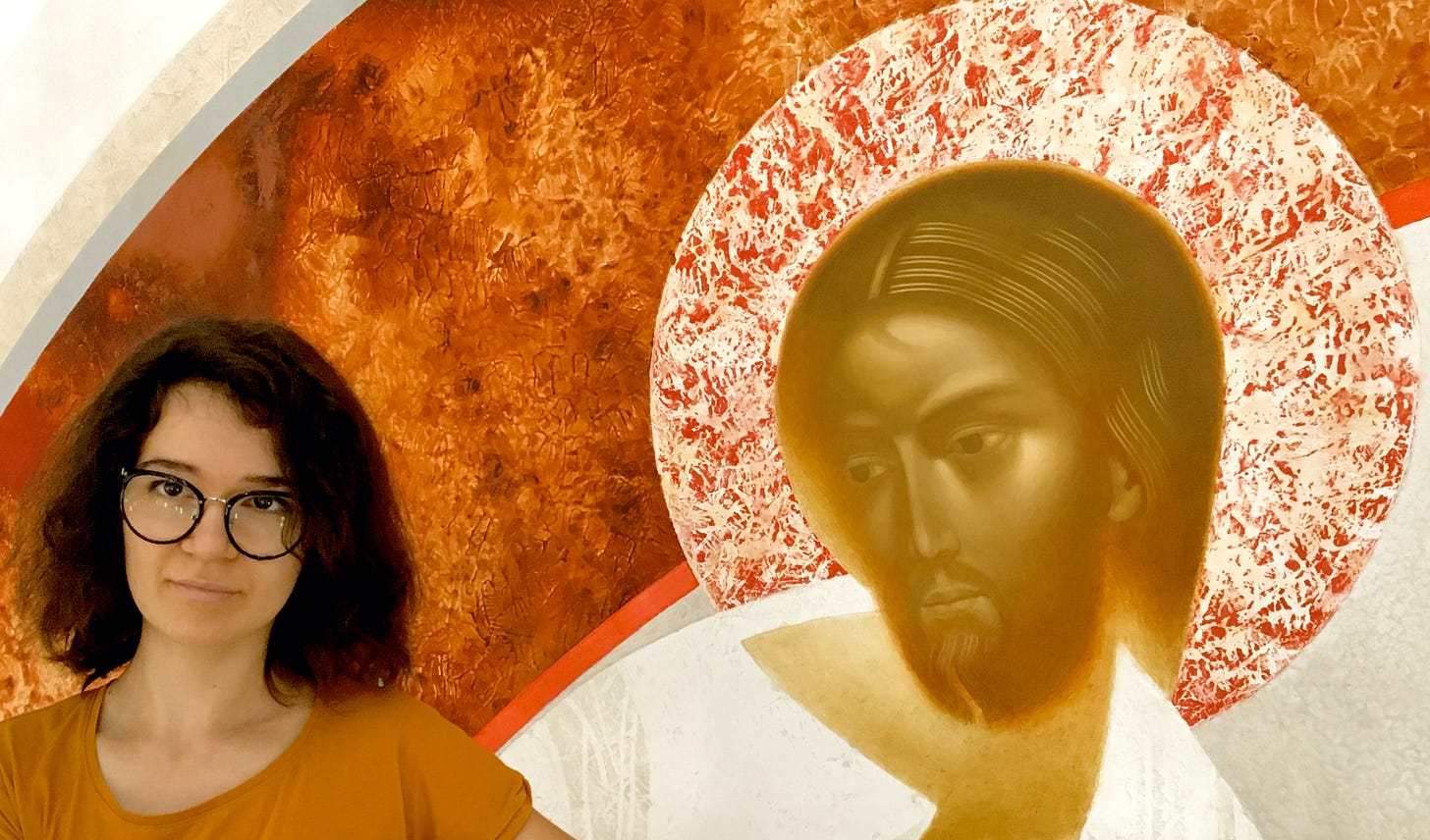 The painter Ivanka Demchuk stands in front of a painting called "Resurrection," which shows Jesus with an orange and white halo behind his head