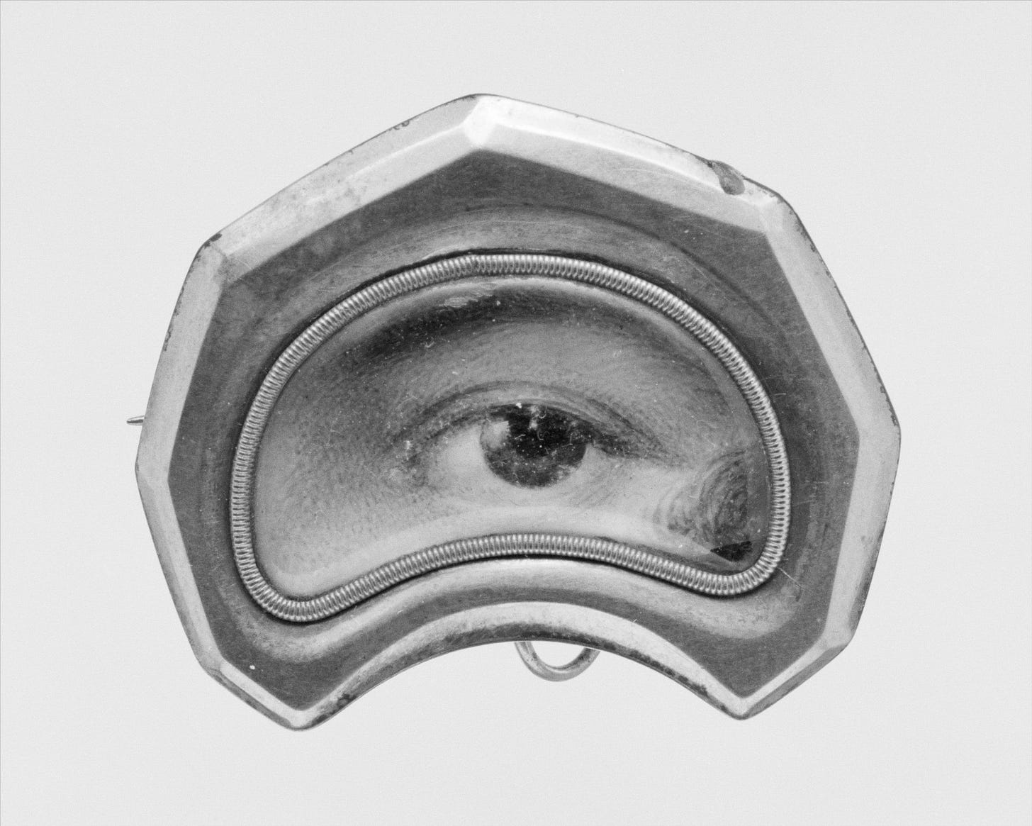 Painted eye encased in a silver brooch.