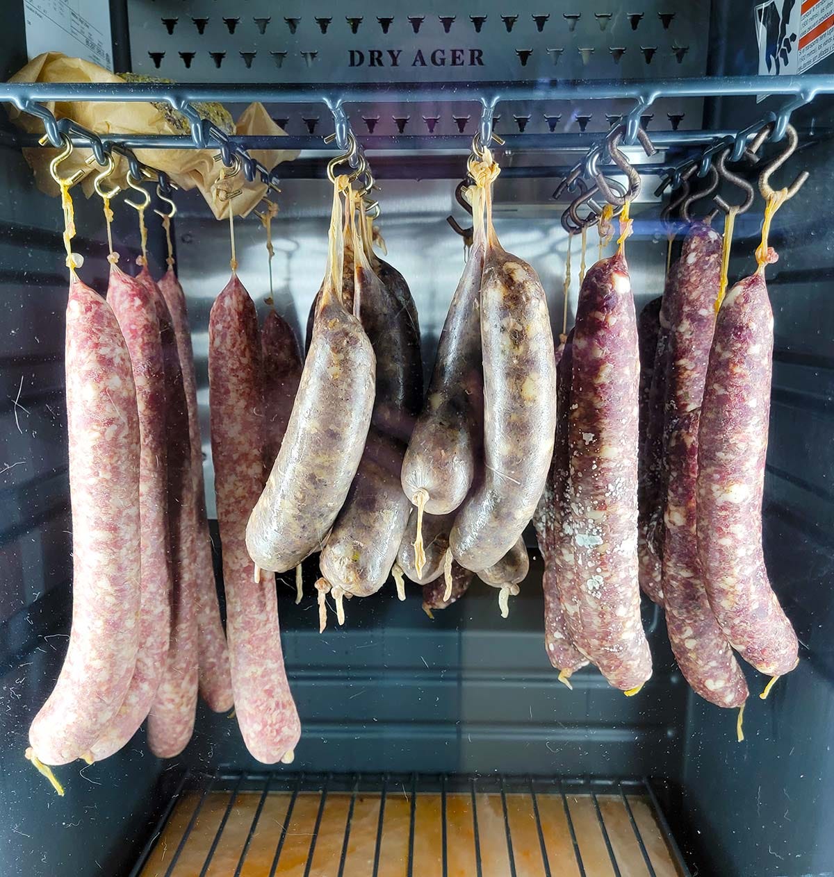 Sausages drying in a curing chamber. 