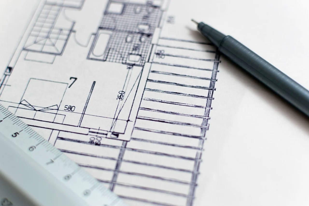 pen, ruler, and house blueprint sketch