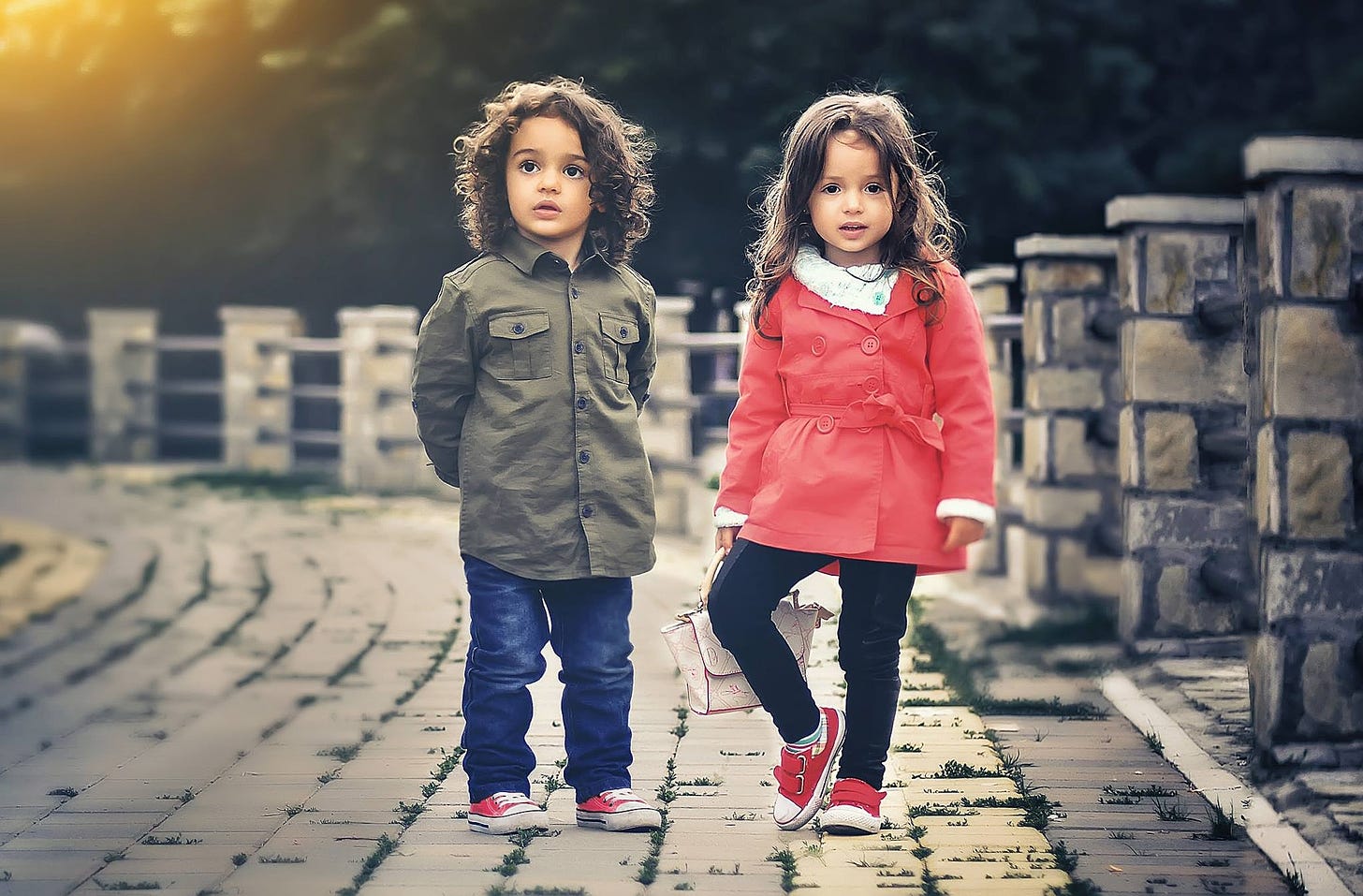 A boy and girl standing on a path.