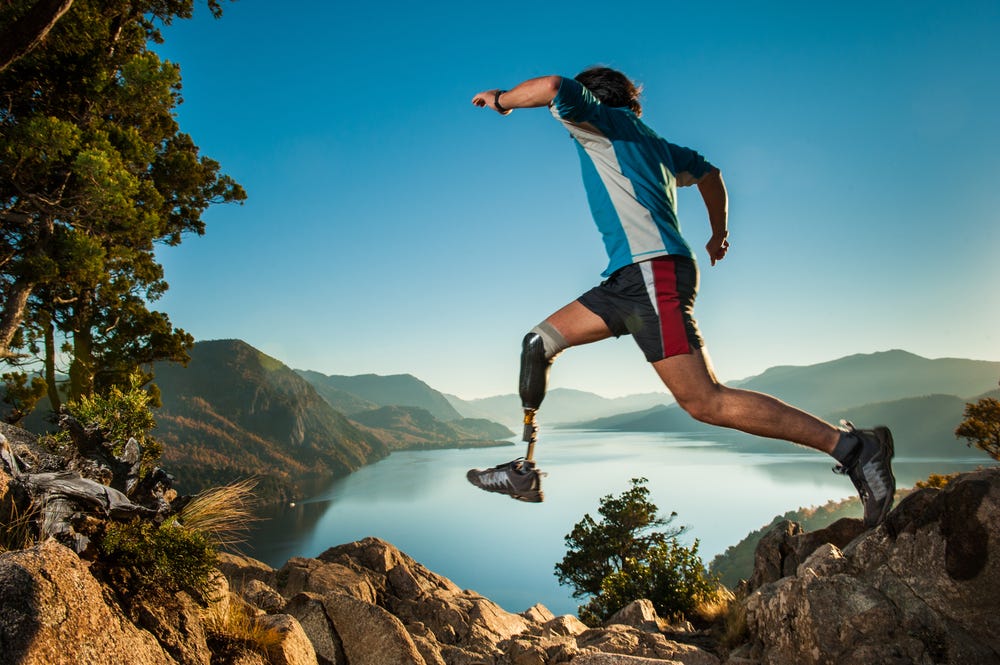 Disabled man with prosthetic leg, jumping in Patagonia