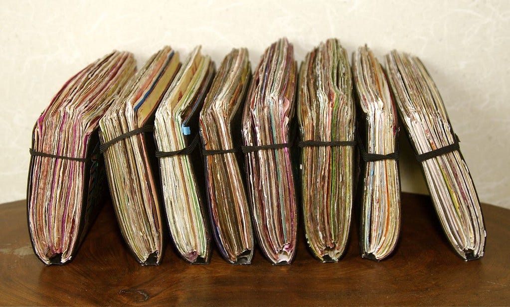 A row of closed, handmade journals. "journals" by gbSk is licensed under CC BY 2.0 