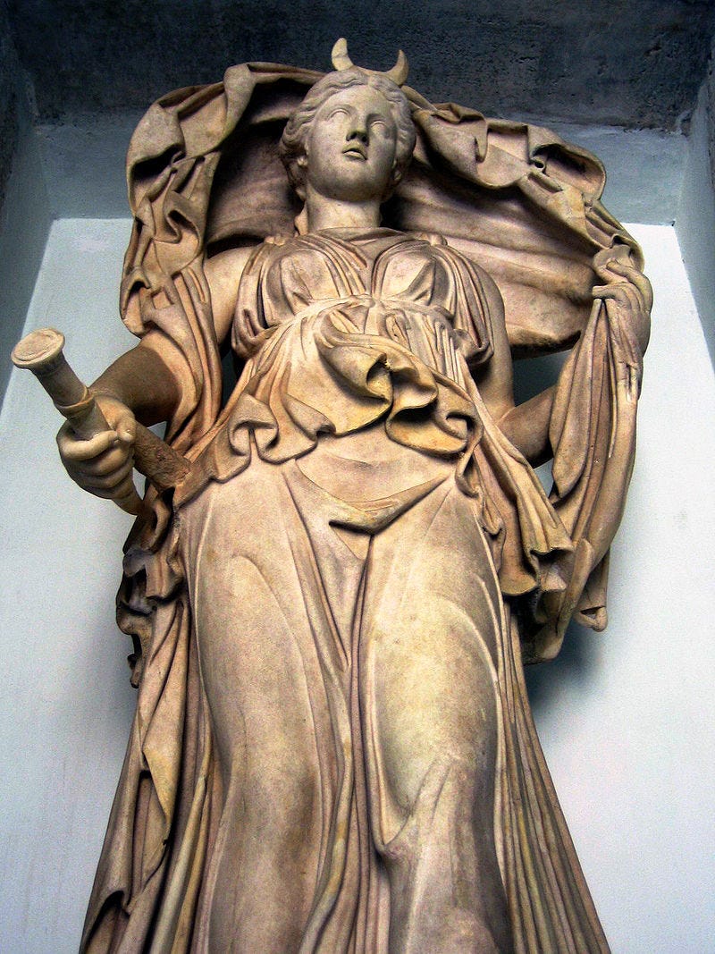 Ancient roman statue of a goddess with cloak.