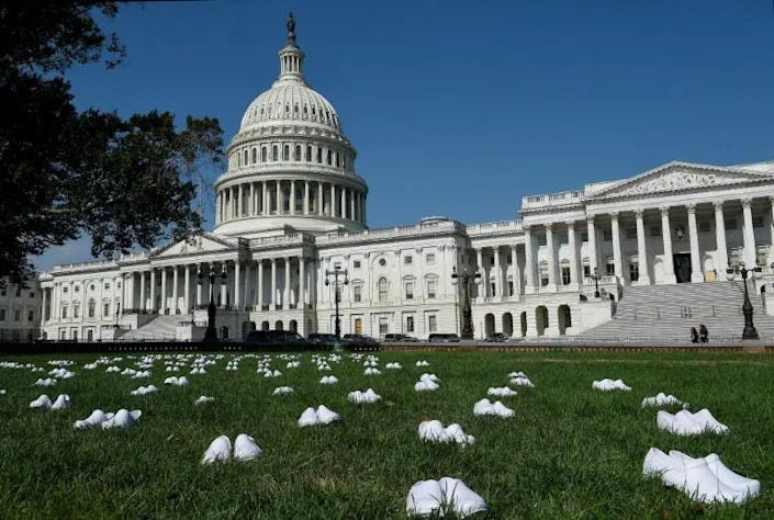 National Nurses United (NNU) display 164 white clogs shoes outside the US Capitol in Washington, DC, US to honor the more than 160 nurses who have lost their lives from COVID-19 in the United States. (AFP Photo/Olivier DOULIERY)