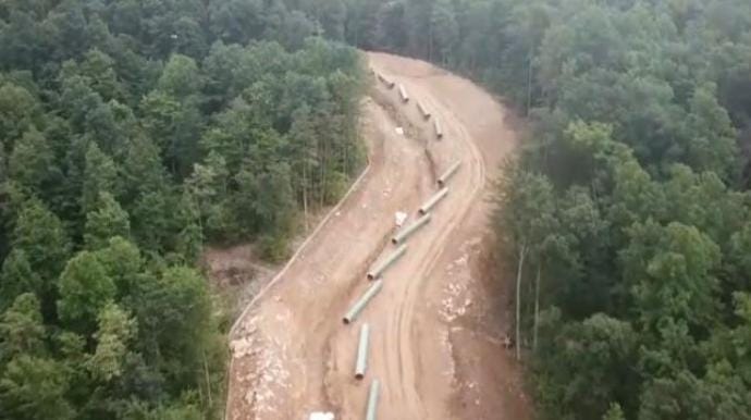 Image of pipeline construction through forest.