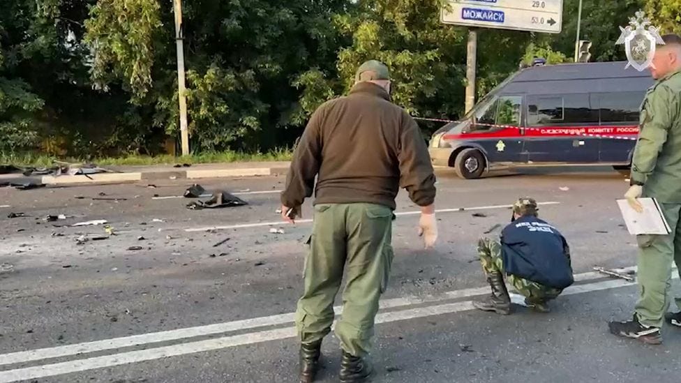 Russian investigators at the scene of the vehicle explosion.