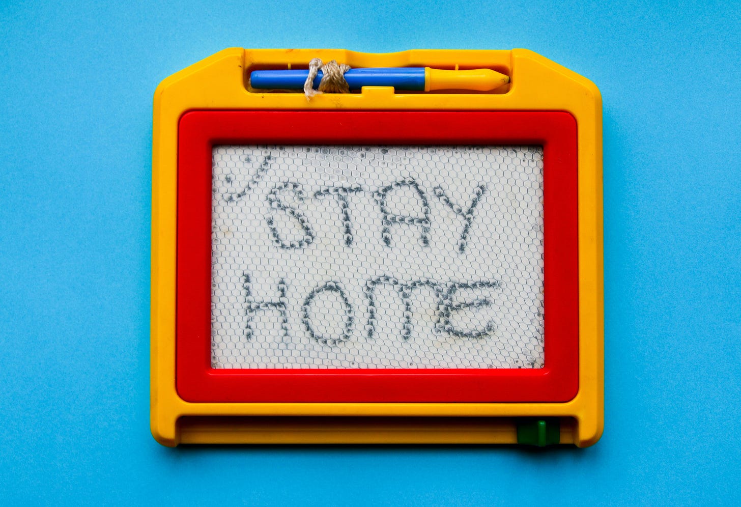 Child's drawing board bearing the words: Stay Home