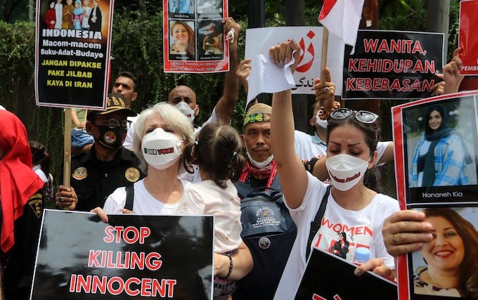 Hundreds of protesters gather to show solidarity for Mahsa Amini, who died in police custody for not wearing her hijab properly, in front of the Iranian Embassy in Jakarta, Indonesia