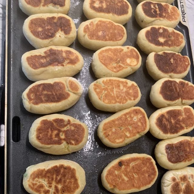 A griddle full of browned cakes