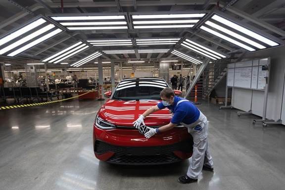 An employee checks a Volkswagen ID.5 eSUV at a factory in Zwickau, Germany.