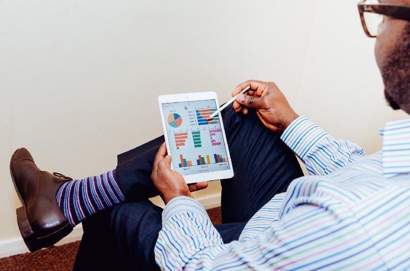 A man looking at some graphs