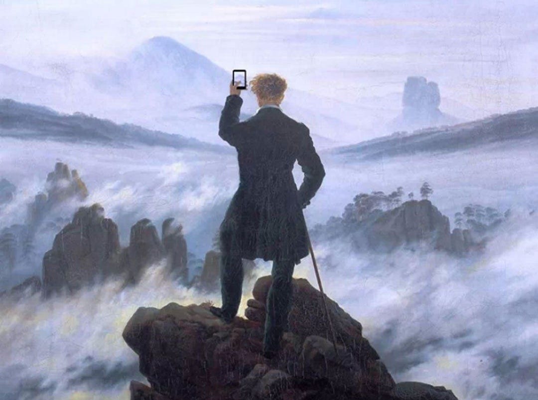 Wanderer above the sea of fog with mobile phone