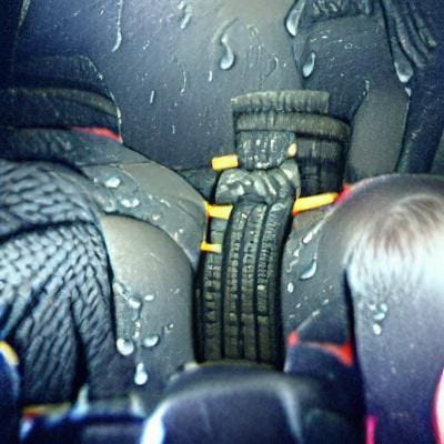 Tires that grip in the wet (shot of baby strapped in back seat)