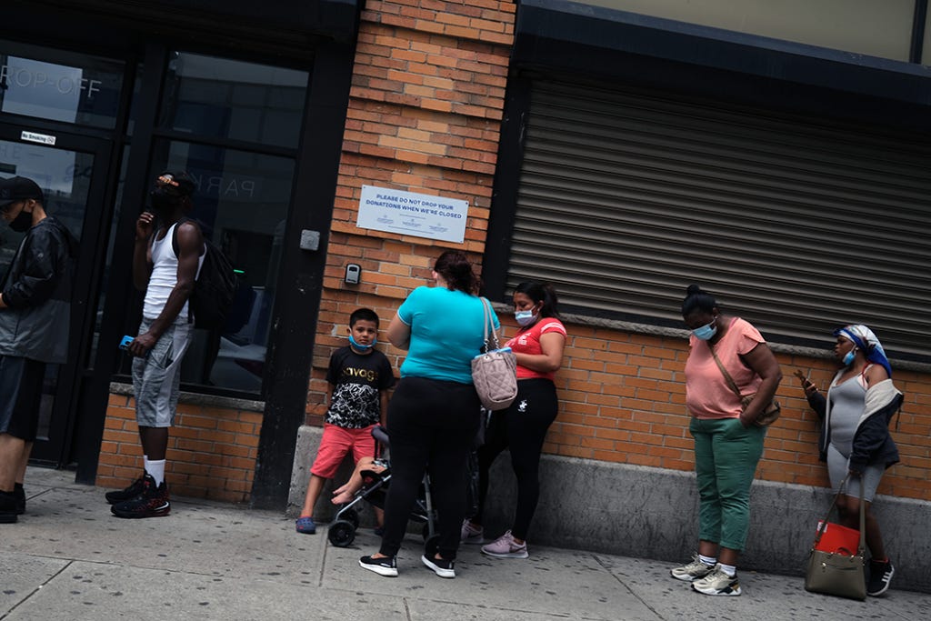 People wait in line for food assistance cards in Brooklyn, New York, July 2020.