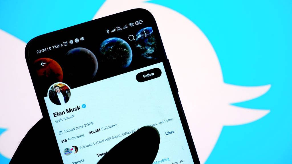 Elon Musk Twitter account against the Twitter logo