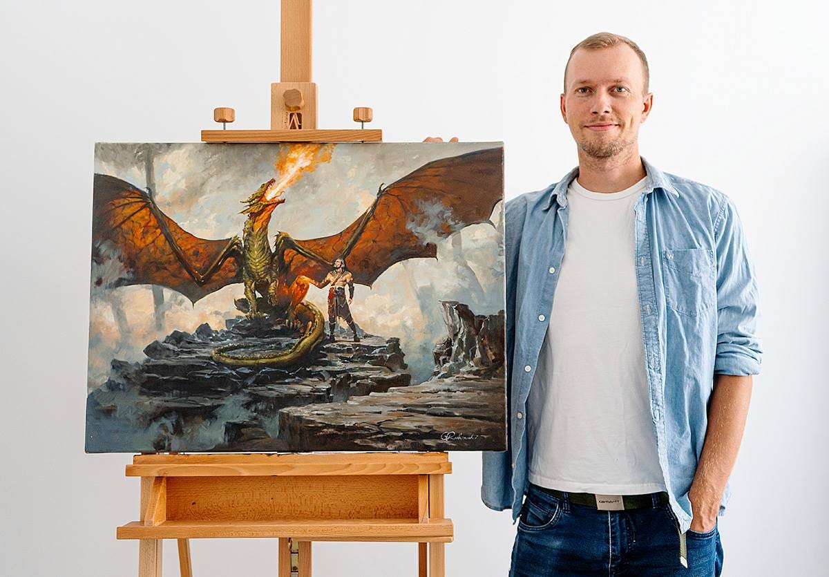 Fantasy artist Greg Rutkowski standing by an easel with his painting of a dragon Scion of Shiv