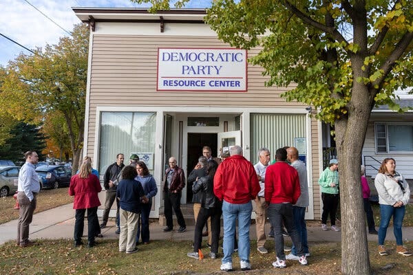 People gathering outside Democratic Party offices in Eau Claire, Wis., after a canvassing event.