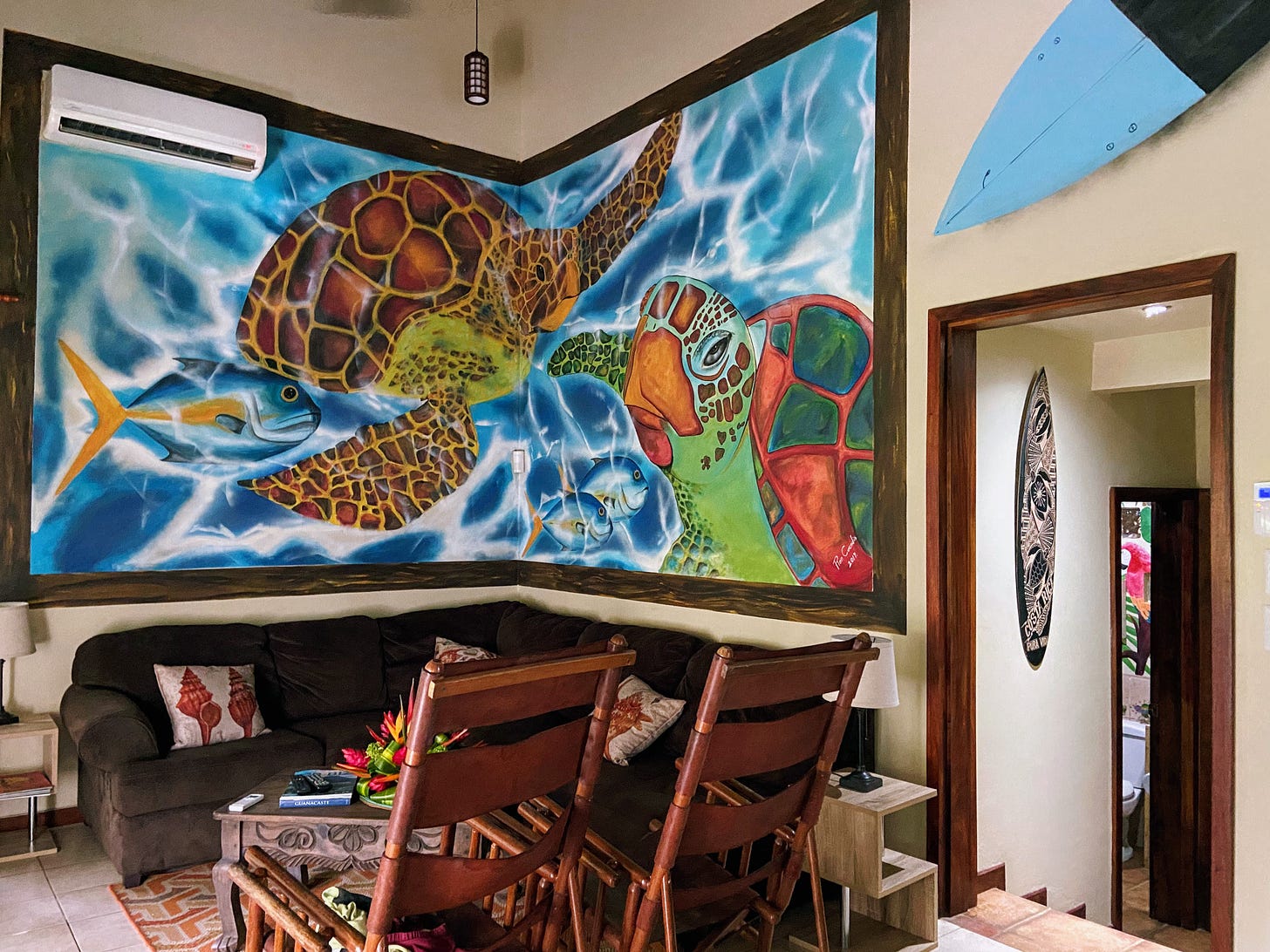 Room with large wall mural of sea turtles and fish