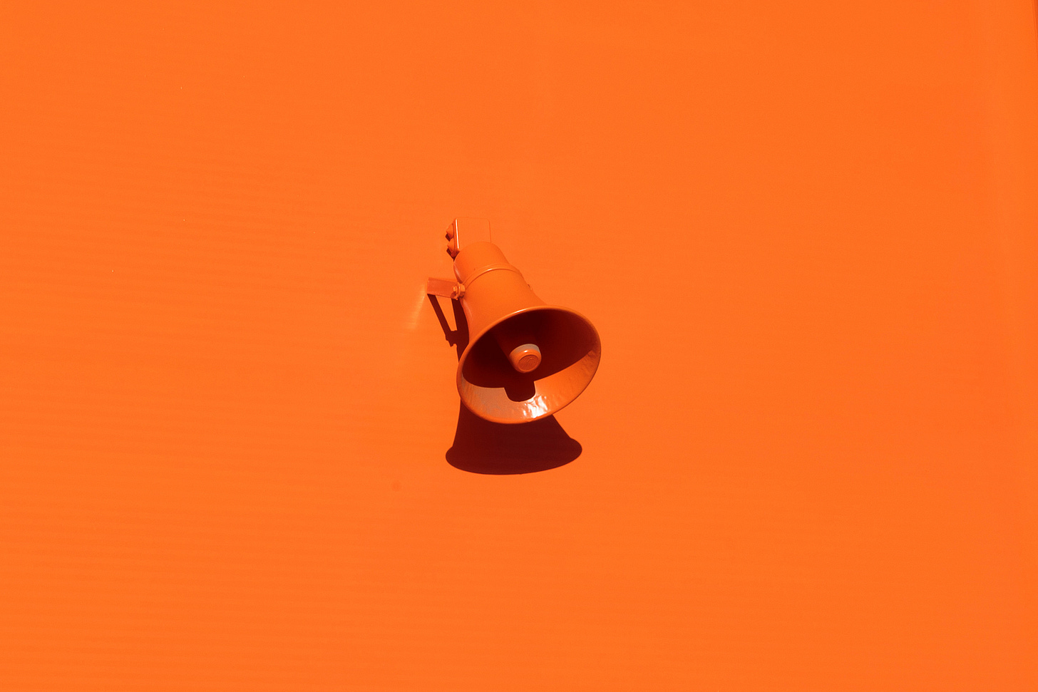 A orange background with a megaphone. A orange background with a megaphone.