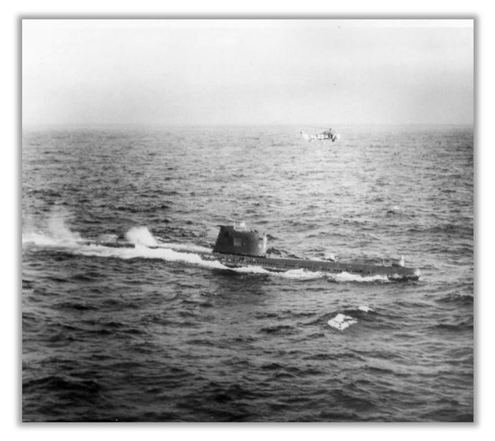 Submarine B-59 is pictured with an American helicopter hovering overhead.