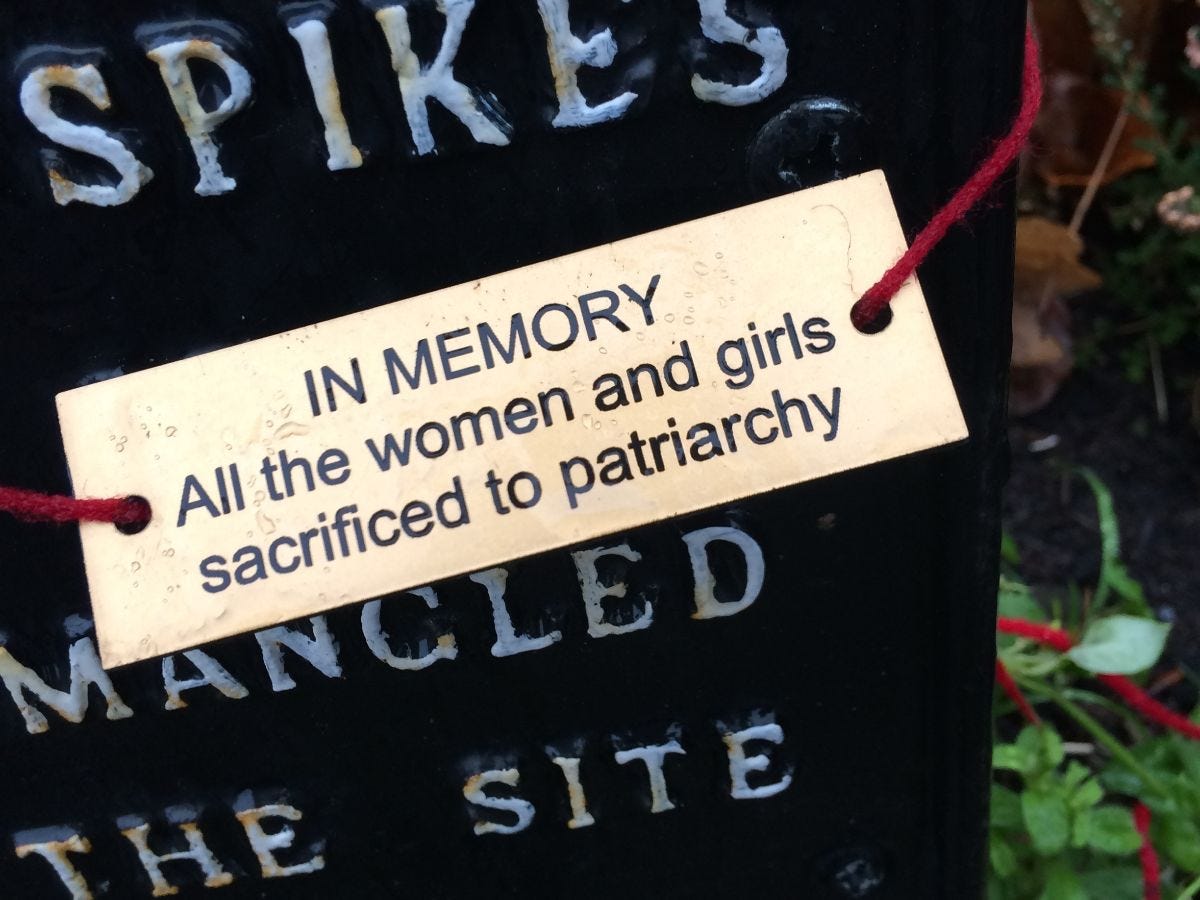 Tag on a memorial sign reading 'IN MEMORY' All the women and girls sacrificed to Patriarchy
