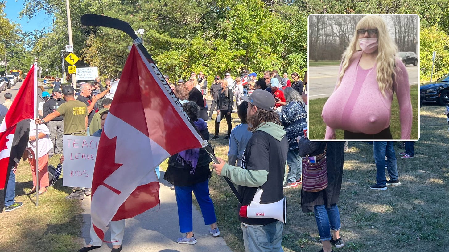 Protesters gather at school for rally against biological male teacher who wears giant prosthetic breasts