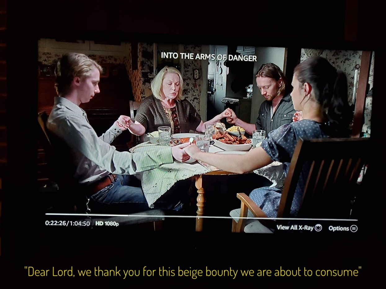 Momma, her two boys, and Jenny holding hands around a small table laden with food, captioned "Dear Lord, we thank you for this beige bounty we are about to consume"