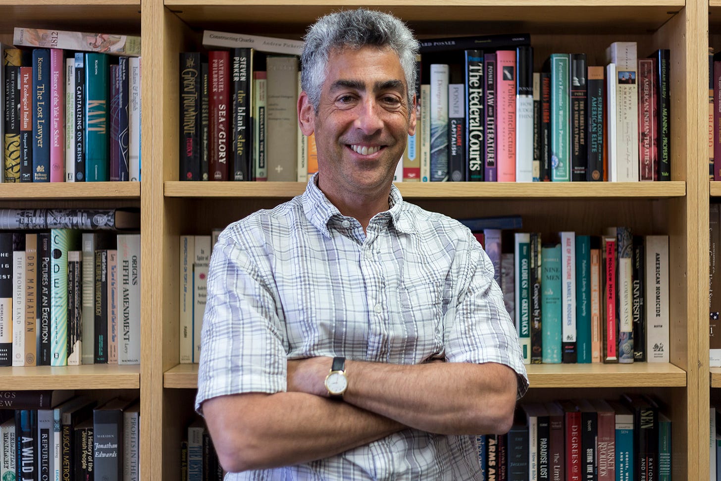 This 2017 image shows Dr. Stuart Banner standing in his UCLA office before a wall of bookshelves. Banner, with arms crossed across his chest, smiles directly into the camera. This 2017 image shows Dr. Stuart Banner standing in his UCLA office before a wall of bookshelves. Banner, with arms crossed across his chest, smiles directly into the camera.