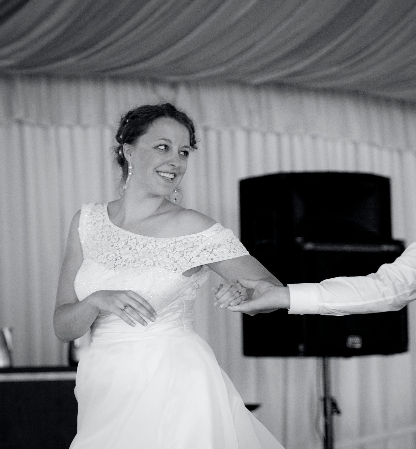 a b&w photo of me dancing at my wedding reception in a boat-neck lacy dress