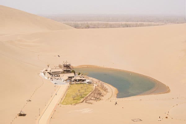 A temple on Crescent Lake at Mingsha Shan (Echoing Sand Mountain) near the town of Dunhuang in Gansu, China. Dunhuang was an important strategic base along the ancient Silk Road, near the entrance to the Hexi Corridor.