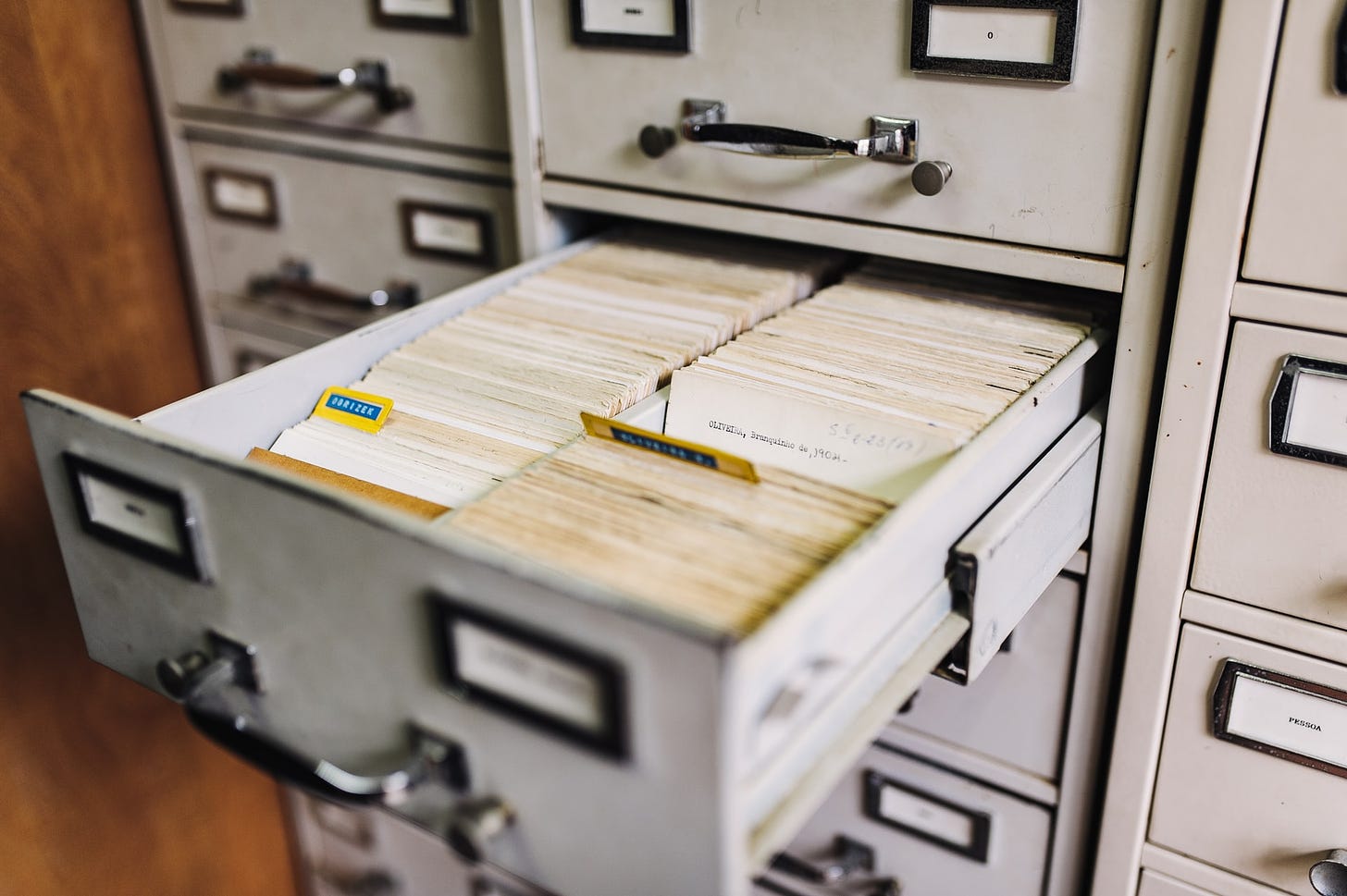 Old school library card catalogue with two side by side rows of index cards. Not actually a recipe box, but the best stock photo i could find. But could you imagine this many recipes? 