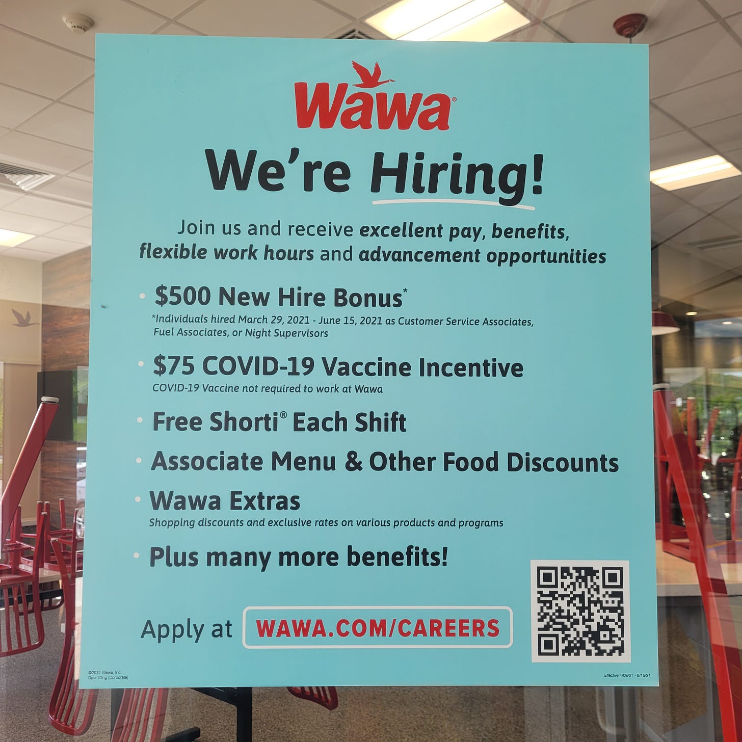 A sign at Wawa announcing the perks of working there, including a $500 hiring bonus, vaccine incentive, employee meals, discounts, and more.