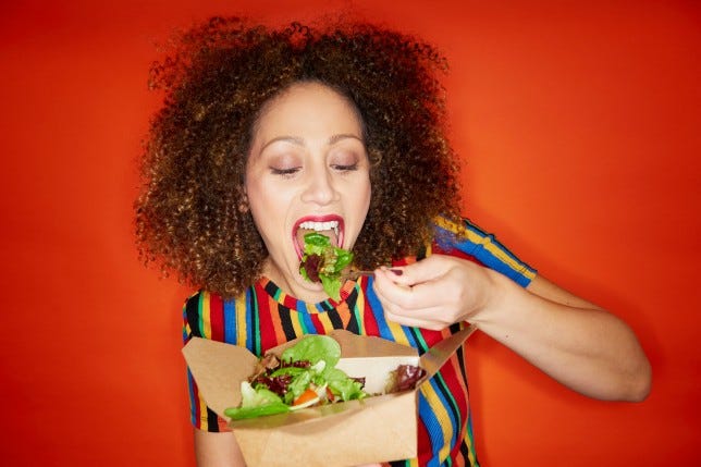 woman eating takeout salad