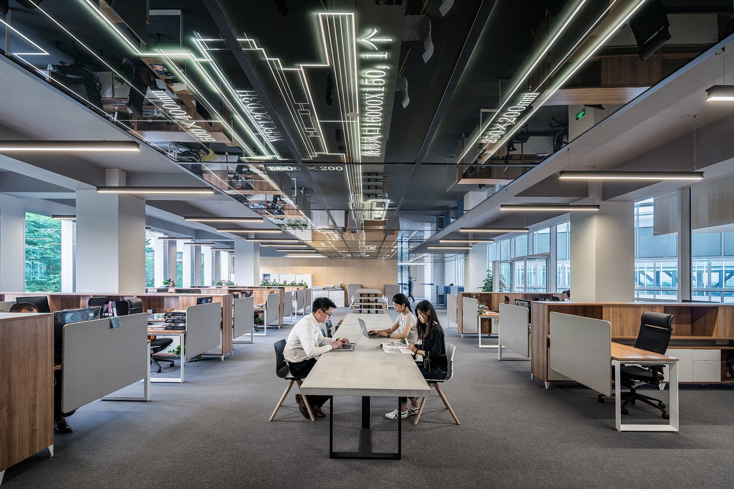 Image of workers working in an open plan office for article by Larry G. Maguire