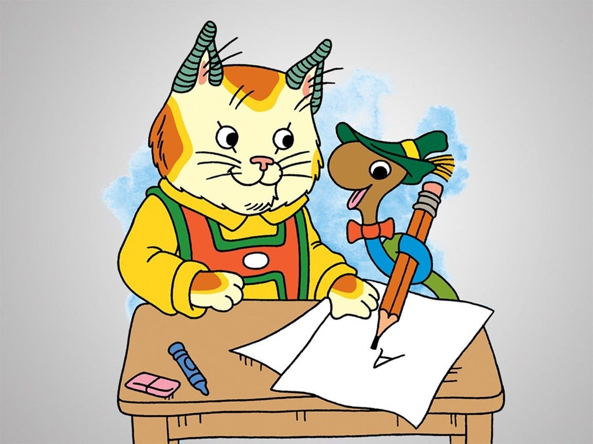 Huckle Cat, a cat wearing a shirt, and Lowly Worm, a worm wearing a bowtie and hat, sit at a desk. Lowly Worm has his worm body wrapped around a pencil, which he is using to write the alphabet.