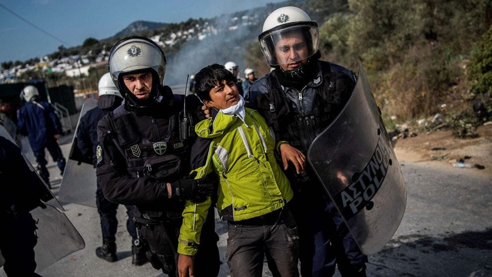 PHOTO: Riot police detain a migrant during clashes near the Moria camp for refugees and migrants, on the island of Lesbos, March 2, 2020. 