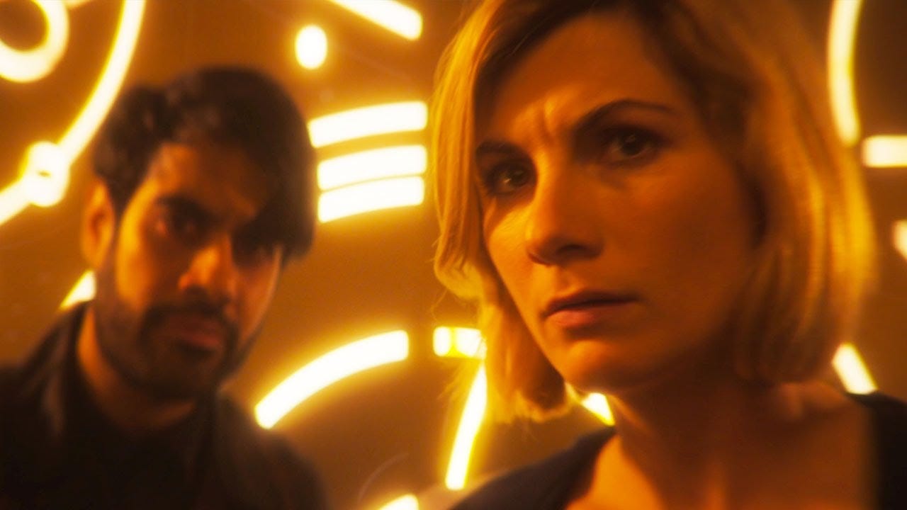 This image shows the Master (played by Sacha Dhawan) on the left and the Thirteenth Doctor (played by Jodie Whittaker) on the right, with the Doctor closer to the camera than the Master. They stand inside Gallifrey's Matrix of Time, in front of lighted Gallifreyan symbols. This image shows the Master (played by Sacha Dhawan) on the left and the Thirteenth Doctor (played by Jodie Whittaker) on the right, with the Doctor closer to the camera than the Master. They stand inside Gallifrey's Matrix of Time, in front of lighted Gallifreyan symbols.