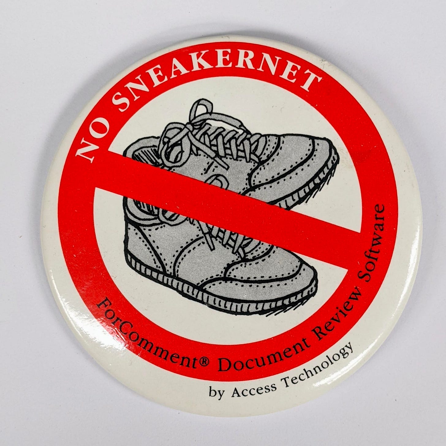 a white button with a red circle & strikethrough over a grayscale drawing of sneakers, with white text saying "no sneakernet" and black text saying "ForComment Document Review Software"