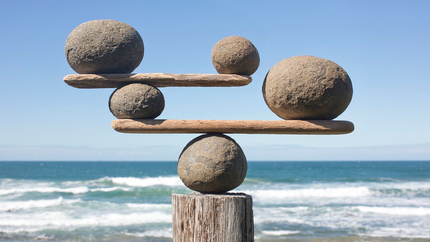 Rocks balancing on an ocean background.