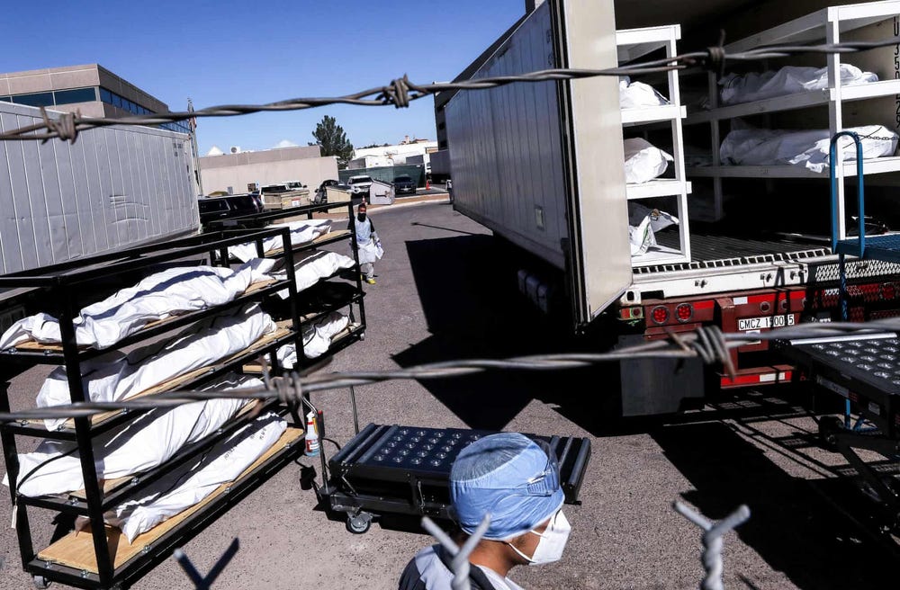 El Paso Texas inmates load Covid-19 corpses into refrigerated trailers due to overflowing morgues and insufficient labor to handle the work.