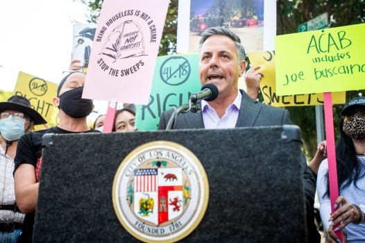 With chanting homeless advocates behind him Los Angeles City Councilman Joe Buscaino holds a news conference in Hollywood on Monday, August 16, 2021 announcing his plans to introduce a resolution banning sidewalk encampments around all public schools in Los Angeles as part of the city’s new anti-camping law that goes into effect on Sept. 3. Buscaino is running for mayor. (Photo by Sarah Reingewirtz, Los Angeles Daily News/SCNG)
