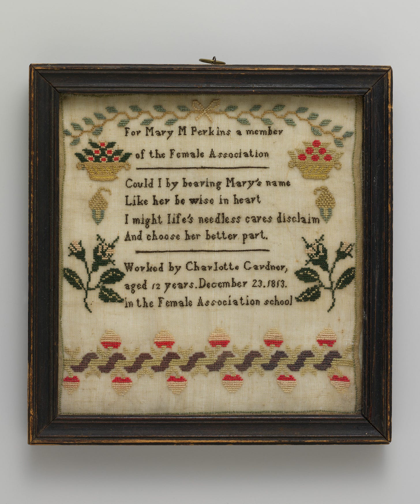 Elaborately embroidered sampler reading: "For Mary M Perkins a member of the Female Association. Could I by bearing Mary's name Like her be wise in heart I might life's needless cares disclaim And choose her better part. Worked by Charlotte Gardner, aged 12 years. December 23, 1813. in the Female Association school."