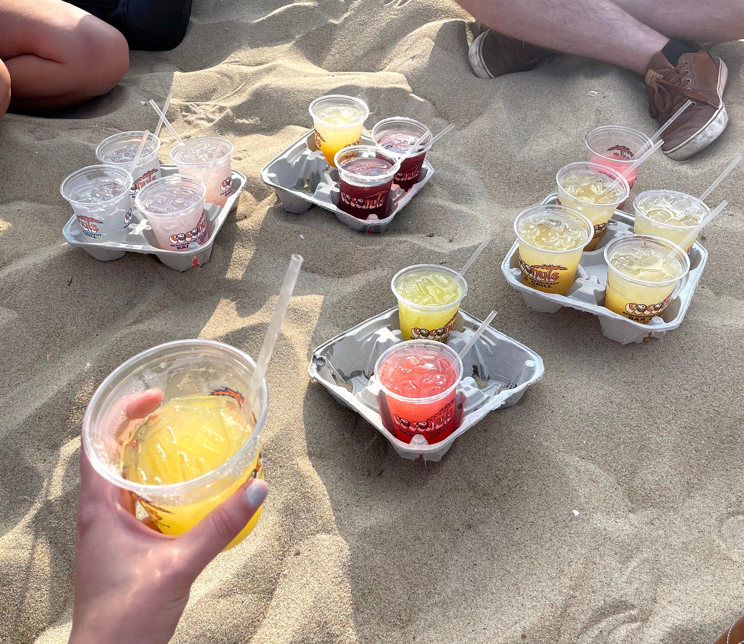 crush cocktails in plastic cups on the sand of ocean city maryland