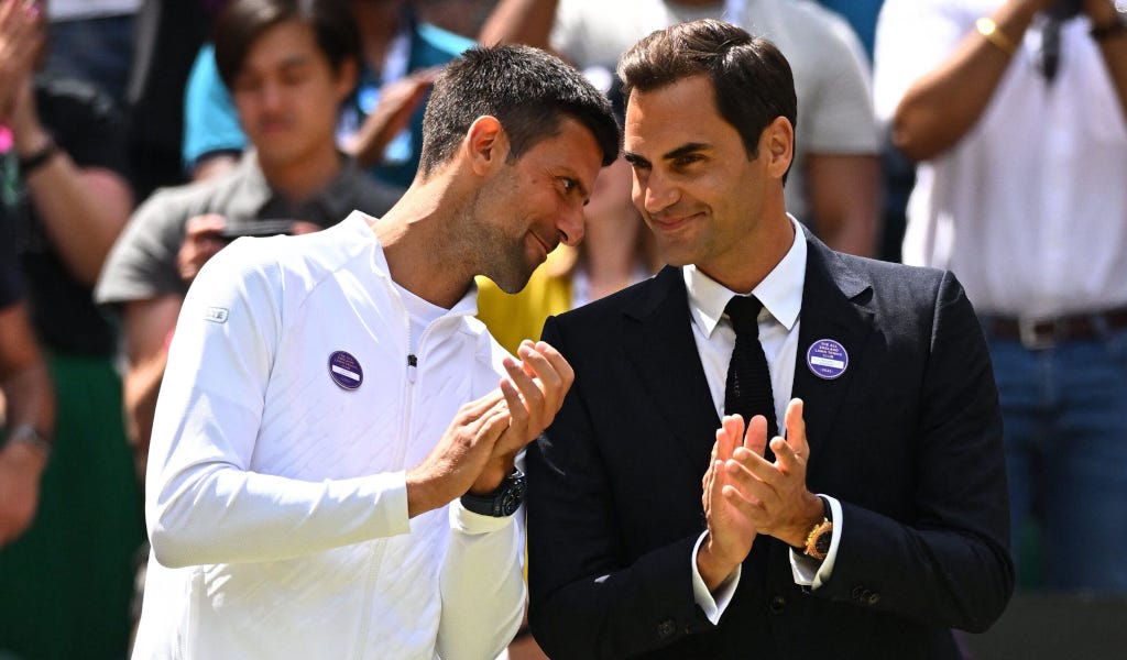 Novak Djokovic whispers to Roger Federer during Wimbledon’s 2022 Centre Court celebrations.