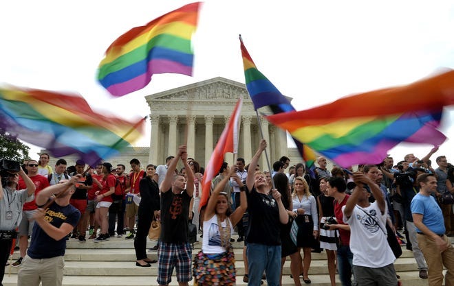 In this file photo taken from June 26, 2015, people celebrate outside the Supreme Court after the court legalized same-sex marriage.